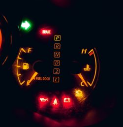 black and yellow analog speedometer